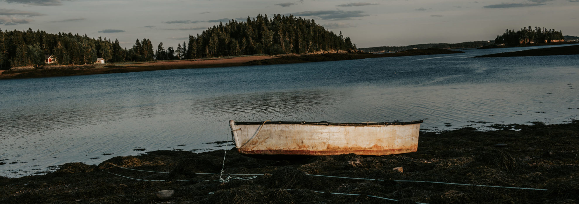 dingy on land at sunset